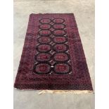 An eastern red ground rug. 77' x 46'