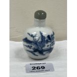 A Chinese blue and white porcelain snuff bottle with hardstone stopper. 2¾'