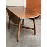 An oak drop leaf dining table on moulded square splayed legs. 42' wide