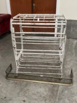 A metal campaign style bedstead and a brass fender