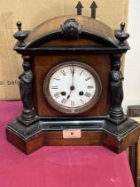 A walnut and ebonised cased mantle clock with French drum movement. 11' high.