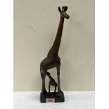 An African carved wood giraffe and calf group.