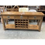 An oak dresser base with three drawers over wine rack. 71'wide.