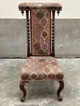 A Victorian rosewood prie-dieu with barleytwist turned back on cabriole legs