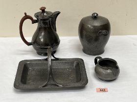 Three items of Tuderic pewter to compromise a rectlinear basket; a jar and cover and a cream jug,