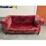 A Victorian chesterfield sofa on turned feet. 66' wide