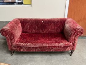 A Victorian chesterfield sofa on turned feet. 66' wide