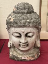 A terracotta head of a Buddha. 20' high. Damage, losses.