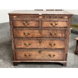 A George III oak and mahogany crossbanded chest of drawers on bracket feet. 43' wide