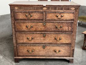 A George III oak and mahogany crossbanded chest of drawers on bracket feet. 43' wide