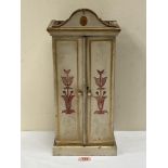 An Edward VII decorated pine cabinet enclosed by a pair of doors. Dated in pencil under the base