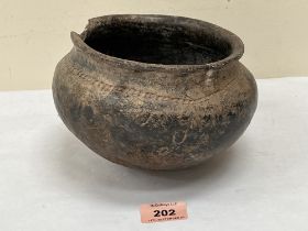 An archaic earthenware storage vessel. Possibly black burnished ware. 7'diam.