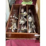 A mahogany cutlery tray with a collection of plated cutlery
