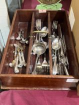 A mahogany cutlery tray with a collection of plated cutlery