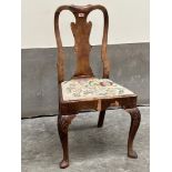 A Queen Anne walnut side chair with shaped splat on shell moulded cabriole forelegs. Veneer losses