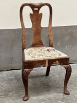 A Queen Anne walnut side chair with shaped splat on shell moulded cabriole forelegs. Veneer losses