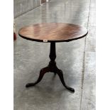 A 19th century mahogany snap-top table on tripod base. 32' diam