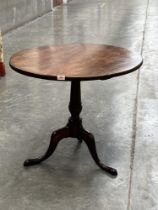 A 19th century mahogany snap-top table on tripod base. 32' diam