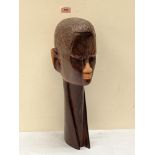 An East African lignum vitae carved male head with extended neck. 20' high, Kenyan