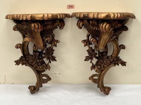 A pair of gilt resinous wall brackets. 18½' high. One cracked