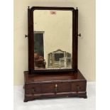 A George III mahogany dressing mirror with three cavetto base drawers on bracket feet. 15' wide