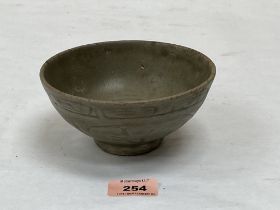 An 18th century Chinese cargoware celadon glazed bowl with sgraffito decoration. 5¾' diam.