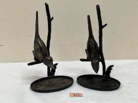 A pair of bronzed metal birds on branch sculptures. 10' high.