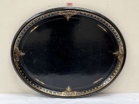 A Victorian papier-mache oval tray in the manner of Jennens and Bettridge. 29½' wide. Losses to rim