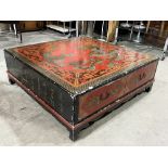 A Chinese red and black lacquer low table, gilded and decorated with dragons; ho-ho birds; flaming