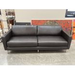 A contemporary style sofa upholstered in black leather. 88" wide.