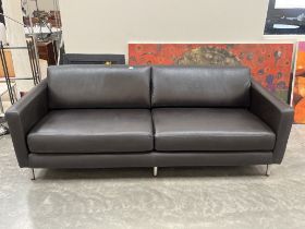 A contemporary style sofa upholstered in black leather. 88" wide.