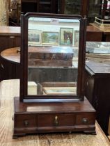 A George III mahogany dressing mirror with three cavetto base drawers on bracket feet. 15" wide.