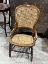 A Victorian side chair with caned balloon back and seat. Back repaired.