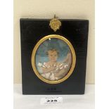 A 19th century portrait miniature of a young child - The ebonised frame 5¼" high.