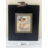 A 19th century portrait miniature of a lady in a wide brimmed hat with white plume. The ebonised