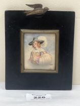 A 19th century portrait miniature of a lady in a wide brimmed hat with white plume. The ebonised
