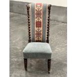A Victorian rosewood prie-dieu chair with barleytwist turned back, on bobbin turned forelegs.