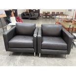 A pair of leather upholstered contemporary style armchairs.