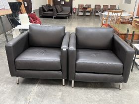 A pair of leather upholstered contemporary style armchairs.