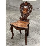 A 19th century walnut marquetry musical chair with shaped foliate carved back. Probably Italian.