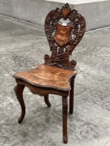 A 19th century walnut marquetry musical chair with shaped foliate carved back. Probably Italian.