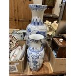 Two oriental blue and white decorated vases, the larger 25" high