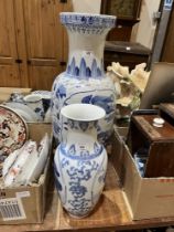 Two oriental blue and white decorated vases, the larger 25" high