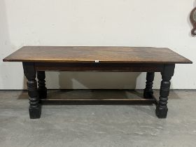 A joined oak refectory table, the cleated top on block and turned supports. 85" long.