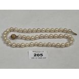 A necklace of knotted pearls with white stone set clasp marked 750. 18" long.