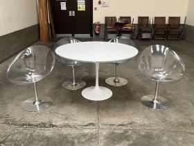 A Italian modernist design dining table with a set of four perspex and steel based chairs.