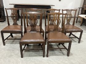 A set of six George III oak dining chairs with shaped pierced splats.