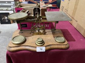 A set of brass letter scales with weights 11½" wide.