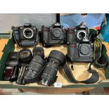 Three Nikon camera bodies, a Canon body; lenses etc.
