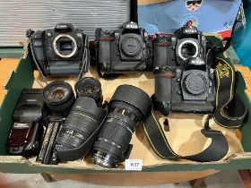 Three Nikon camera bodies, a Canon body; lenses etc.